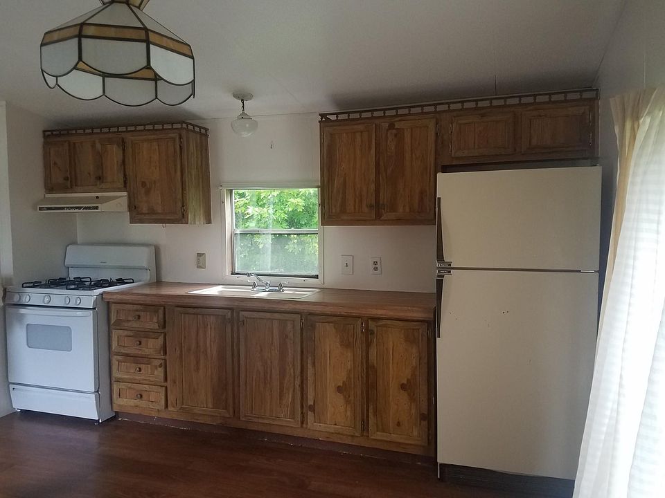 Spacious kitchen with gas stove, refrigerator, bay window, additional storage cabinets