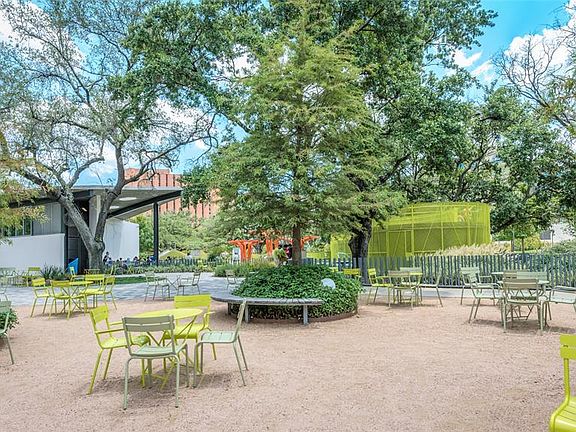 Levy Park with gathering spaces, water feature and climbing structure for the kids.