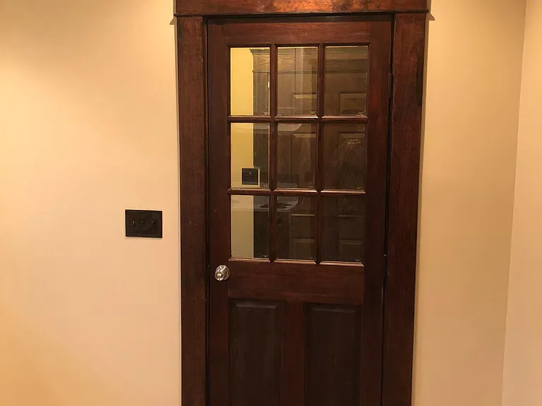 Solid wood doors with original style stained trim throughout the unit.