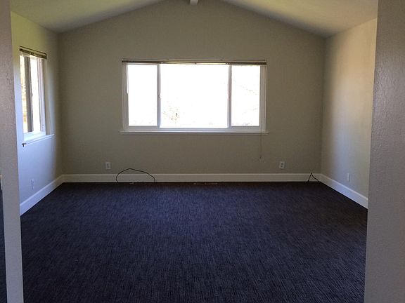 living room seen from front hall without furniture