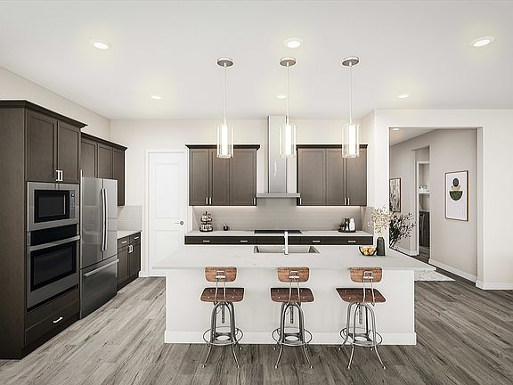 A modern, minimalist kitchen with dark cabinets, stainless steel appliances, and three bar stools at