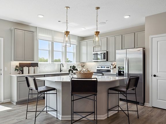 The bright, spacious, and inviting kitchen floods with natural light.