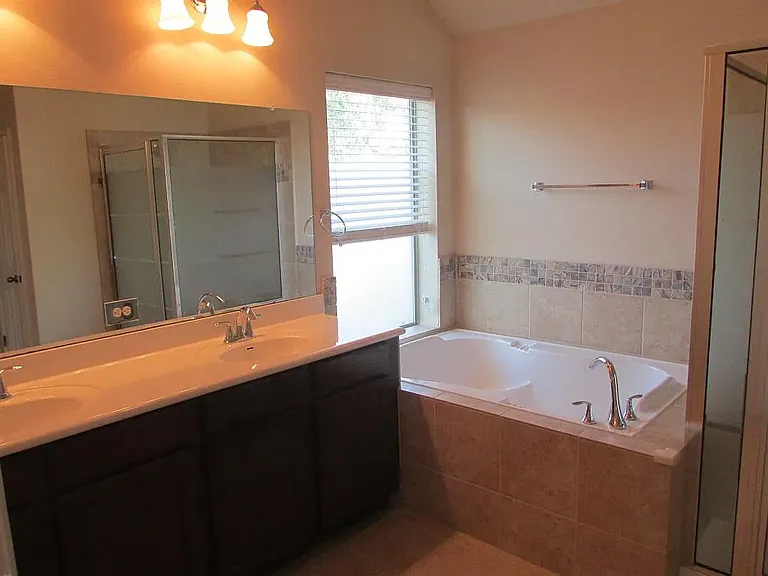 master bathroom with tub and shower