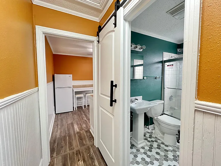 Access to bathroom with Custom sliding door and access to kitchen/dining area!