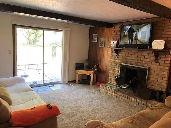 second living room, carpeted with fire place