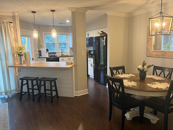 Open-concept layout featuring a butcher-block kitchen island for added workspace and seating.