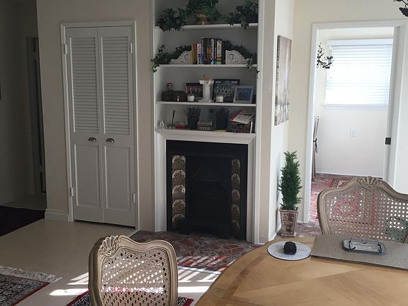 Walk in kitchen with brick laid flooring. Cozy fireplace, wall heaters, built ins and more.