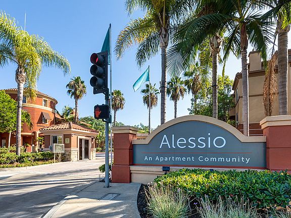 Sign with apartment name with leasing office in the background.