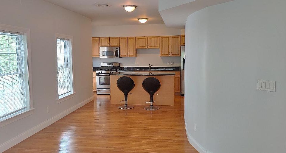 Kitchen area with island and curved wall