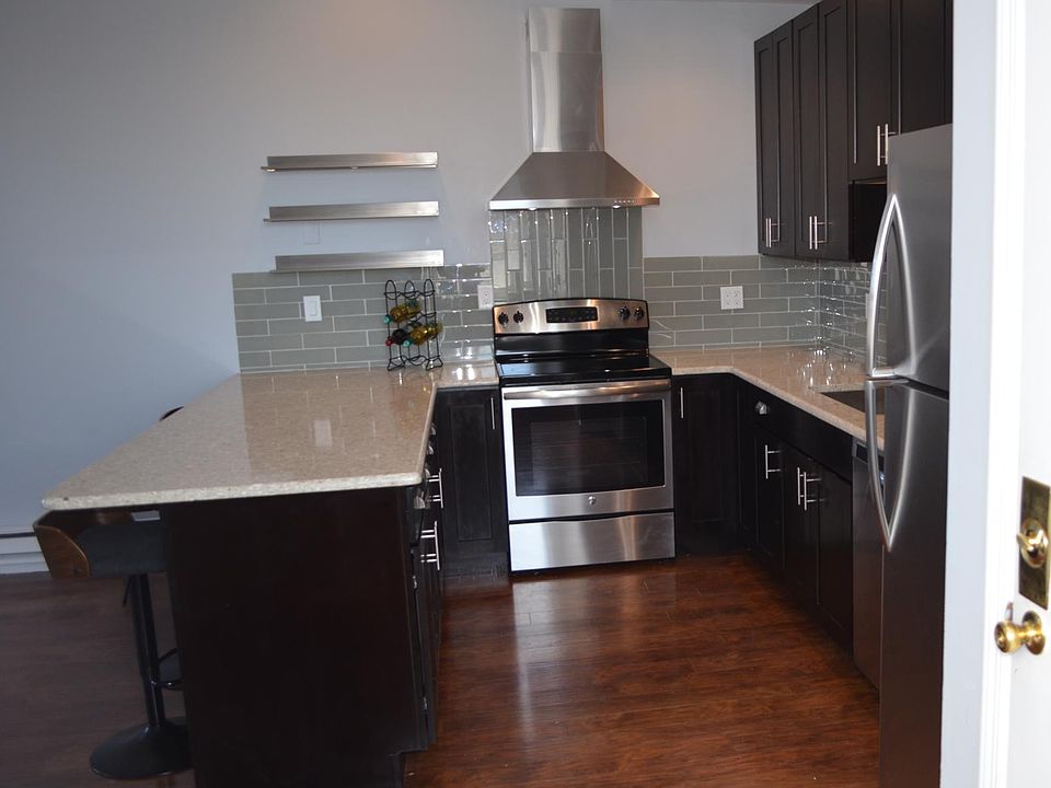 Stone countertops and glass tile backsplash