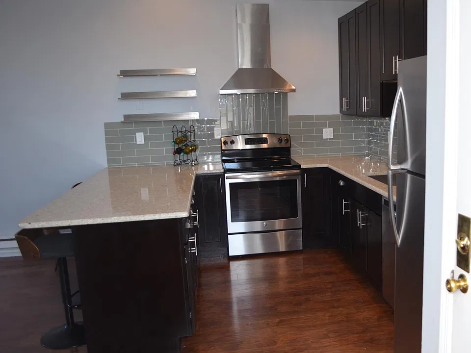 Stone countertops and glass tile backsplash