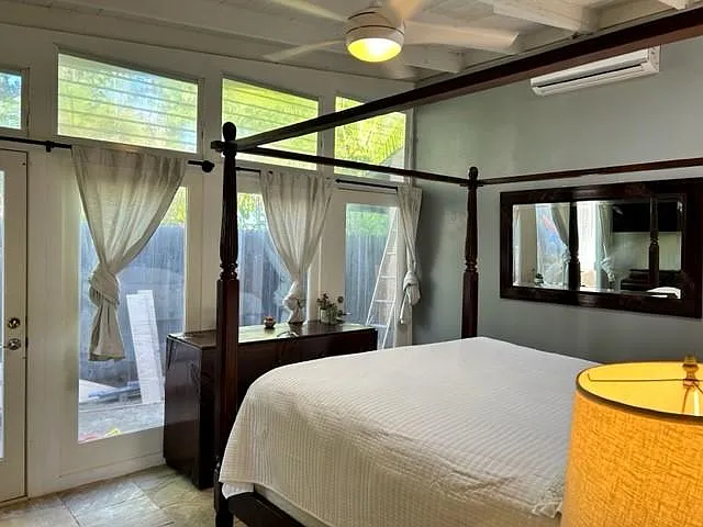 Second Master Bedroom with vaulted ceiling and glass doors to garden