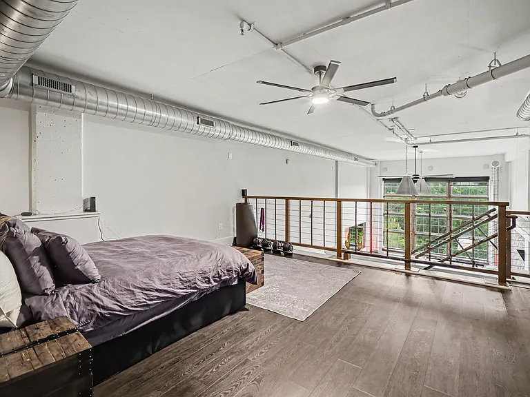 Master Bedroom with stunning brick accent wall, queen bed, 85" Samsung Smart TV, 5.1 sound system, Bowflex bench and adjustable weights up to 52.5 lbs per dumbbell, yoga matt, resistance bands and direct access to master bathroom and walk in closet