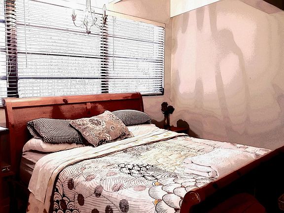 Extra large master bedroom with sitting area and vaulted ceiling.