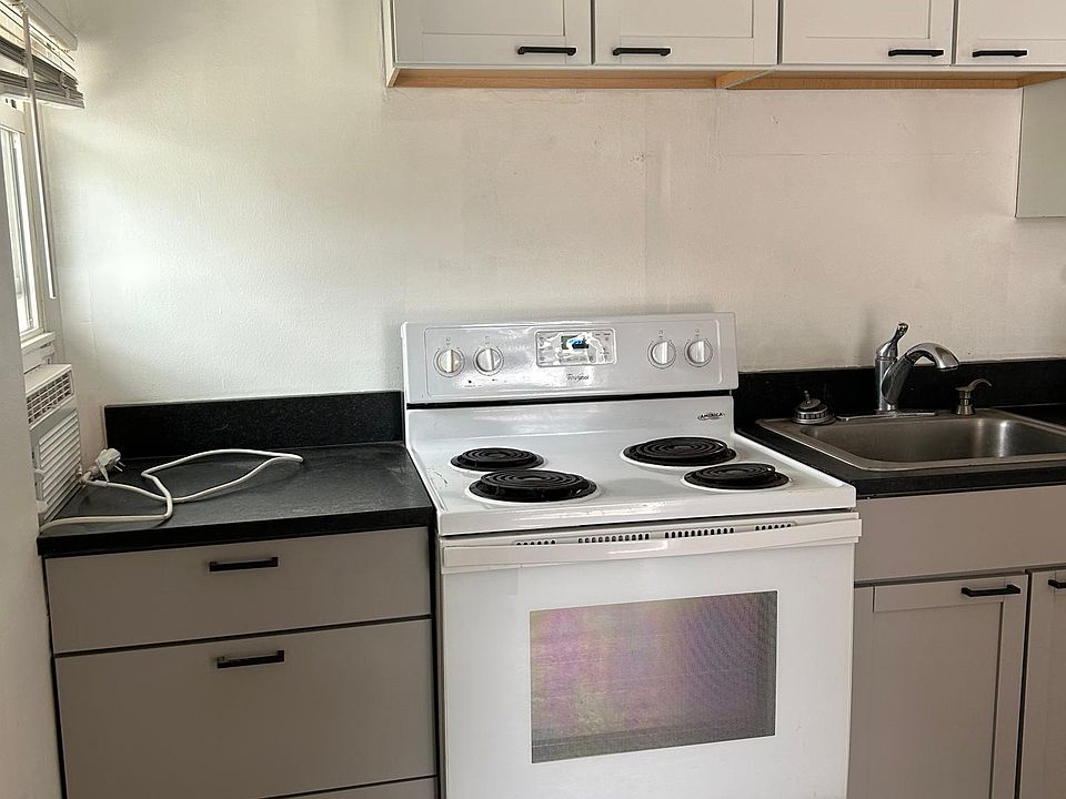 Gray bottom cabinets, white uppers, black muted granite
