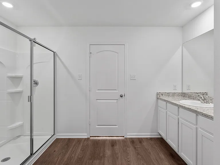 Master bathroom with a large vanity and step-in shower.