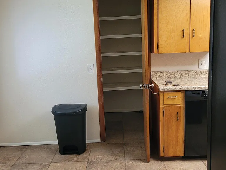 Pantry beside kitchen from living area