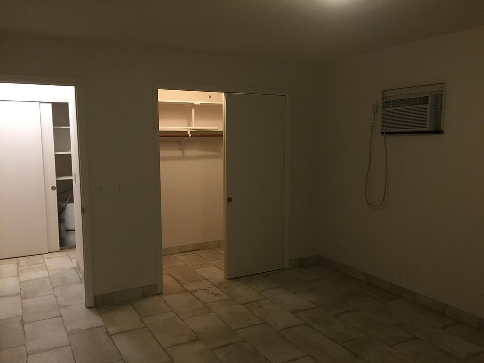 Walk in closet in bedroom. Door leads to hall area with a linen closet.