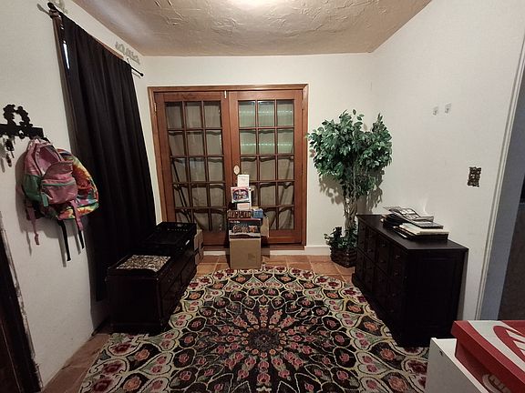 Entry, the previous tenant. Those french doors go to the living room with the firplace.