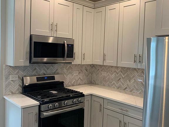 New cabinets, backsplash, and stainless steel appliances