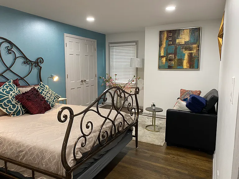 Spacious upstairs bedroom with a queen-sized iron bed _ elegant design meets everyday comfort.