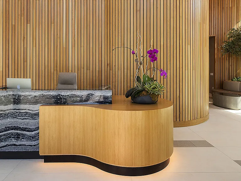 Griffis West Palm apartments leasing center with elegant stone desk.