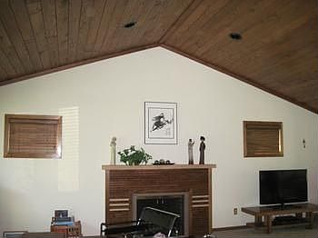 Vaulted living room open and airy with custom designed fireplace.  Wood ceilings and silky carpeting.