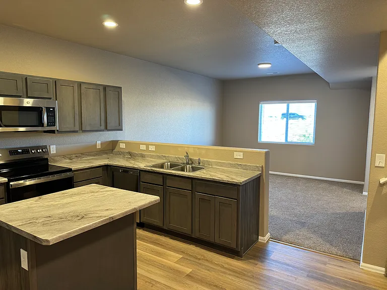 Kitchen opens onto living room