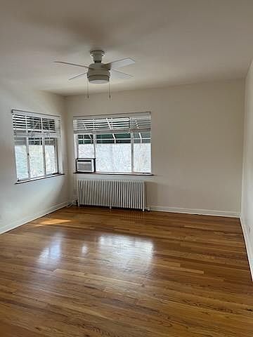 Hardwood floors, ceiling fan, radiant heat and window AC. View of beautiful trees!