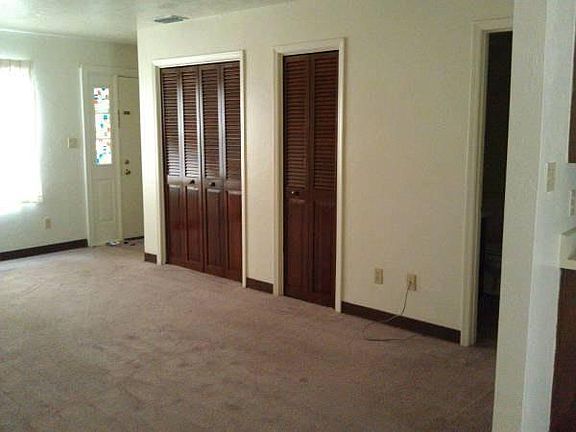 Living room with coat closet, storage closet and 1/2 bath.