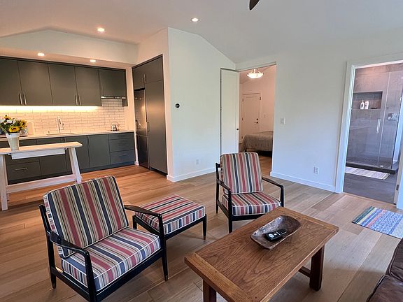View to kitchenette, bedroom, and bathroom from corner of living room.
