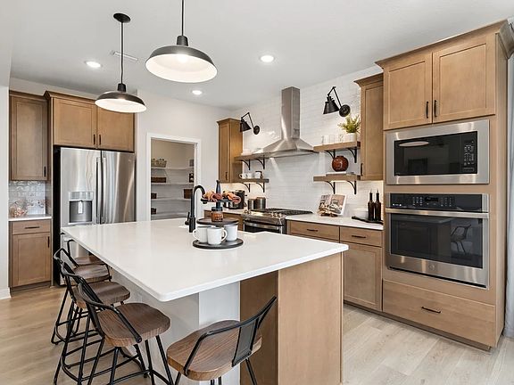 Kitchen with matte black hardware and floating shelves