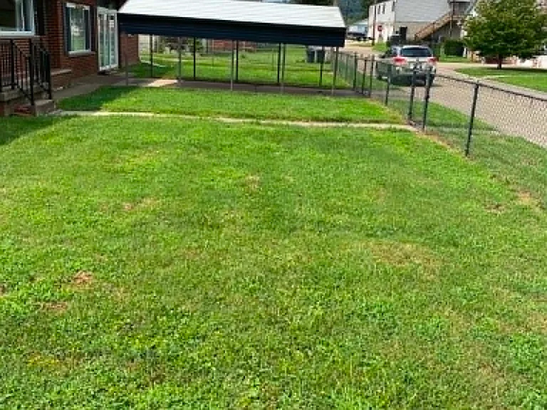 Front yard showing carport. Street parking also available.
