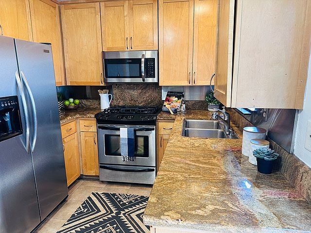Kitchen includes fridge, oven, built-in microwave, dishwasher
