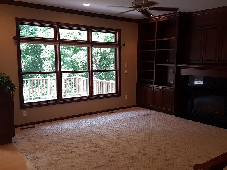 Living room with fireplace and built in cabinets