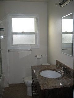 Hall bathroom with shower over tub