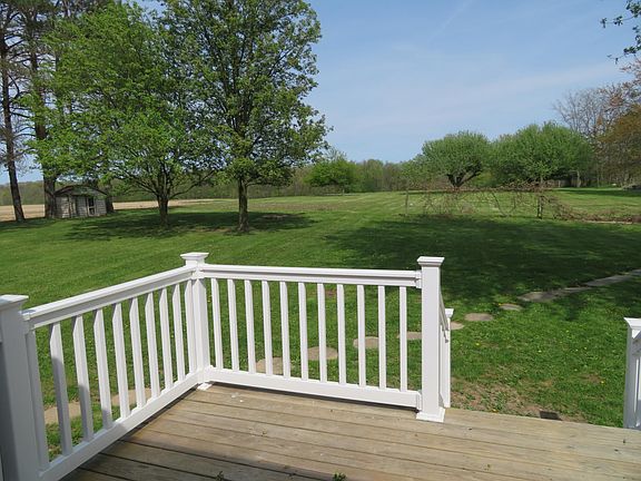 Looking over back yard. Includes fire pit and two trees perfect for a hammock.