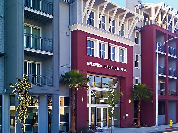 Modern exterior at Belovida at Newbury Park, featuring bold architecture, palm-lined entry, and a welcoming feeling.