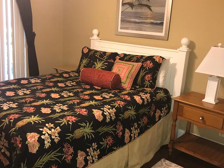 2nd bedroom with queen bed set with two nightstands and dresser