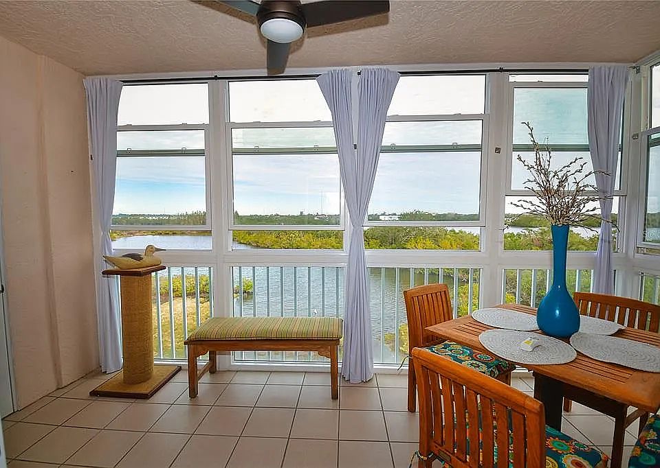 Lanai with bayou views and solid teak dining table.