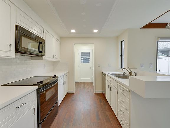 Kitchen view into laundry/mudroom and rear entry from garage