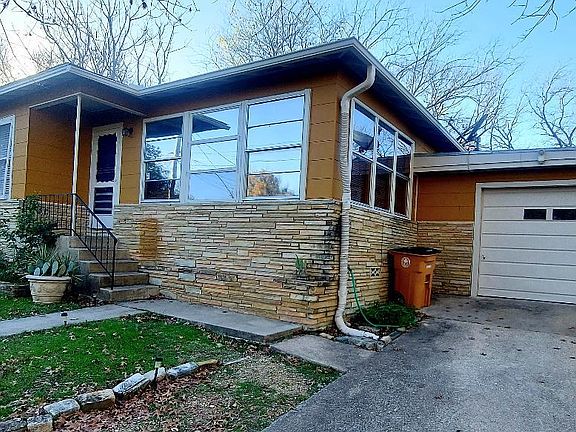 Front of house with garage showing.