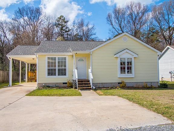 View from front of home, note deck to rear of carport