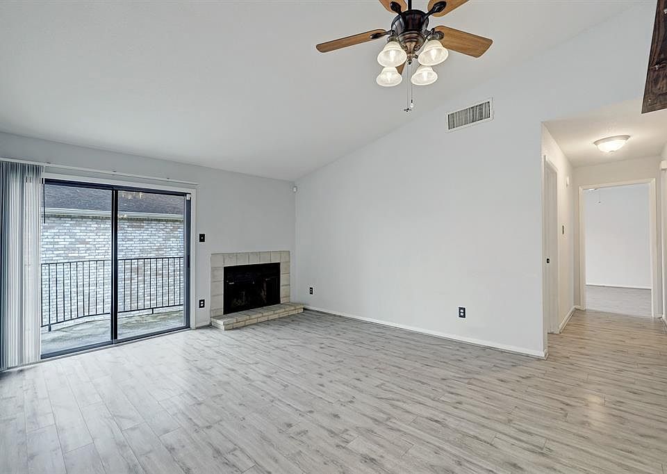 Living room with fireplace and sliding glass door to balcony