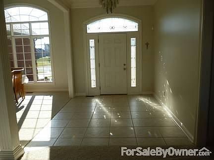 Foyer
						:
						Tiled foyer with 10 & 12 foot ceilings, crown molding & chandelier