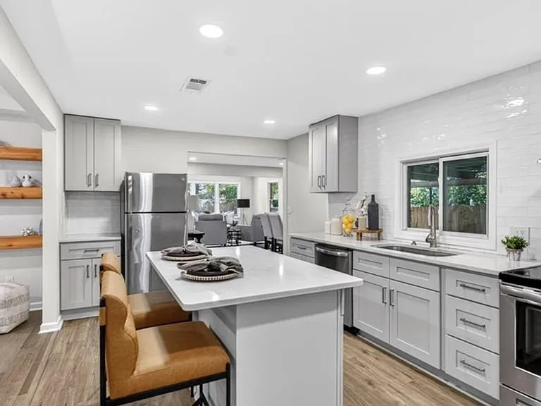 Spacious kitchen with large island, stainless steel appliances, and ample cavinet
