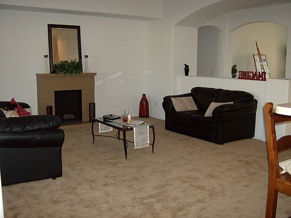 Family Room with vaulted ceiling (faux fireplace can stay if desired)