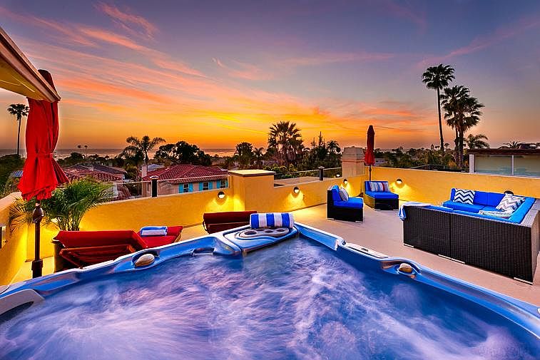 Enjoy panoramic views from your private roof top deck with large seating area, hot tub, outdoor grill & kitchen.