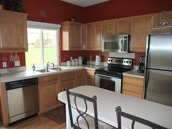 Kitchen with stainless steel appliances. New dishwasher and microwave! Very clean. (New floor not shown in photo)
