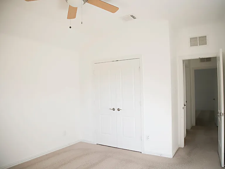 Room with the green accent wall on the right side of the home.